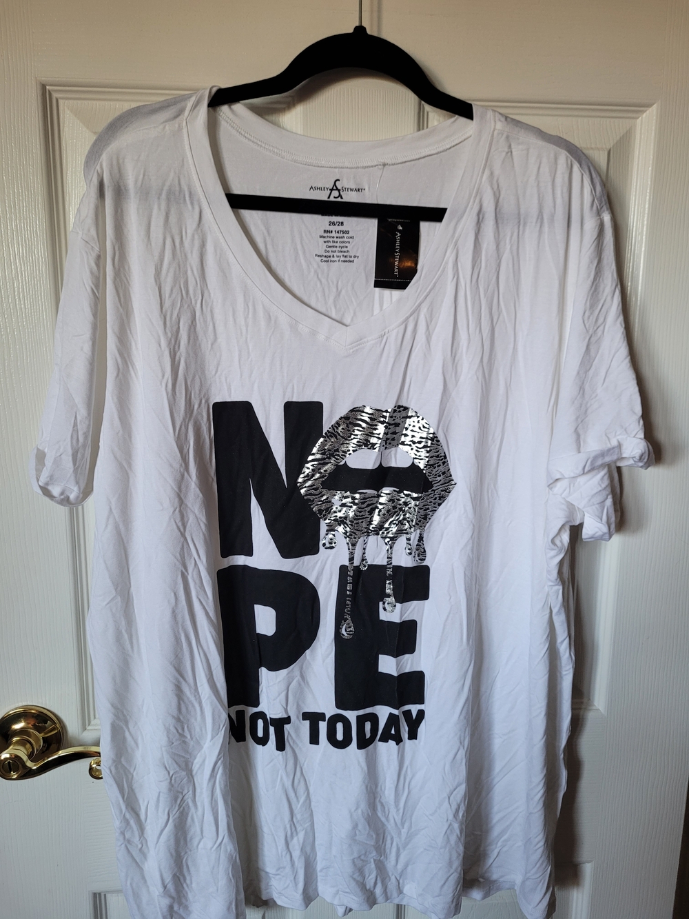 Ashley Stewart White V-Neck Graphic Tee with Black Text and Silver Lip Accent